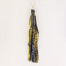 Load image into Gallery viewer, Blue Bead Accented Gold Metallic Leatherette Tassel Necklace
